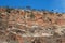 DIFFERENTIATED LAYERS IN ROCK FACE AGAINST A HILL - WHITE QUARTZITE & RED SHALE