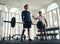 differently abled athlete weightlifting with his coach in the gym. Man with prosthetic leg being coached by his trainer