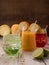 Differents multicolored mocktails on wood table. Freshness fruits on backtop