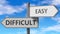 Difficult and easy as a choice - pictured as words Difficult, easy on road signs to show that when a person makes decision he can