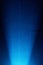 Diffused bright beam of light on a light blue background in a black dot
