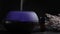 Diffuser for essential oils diffusing steam on black background