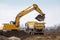 Digger loading trucks with soil