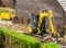 Digger machine working on a garden construction in a modern neighborhood