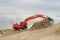 Digger recovering dunes after wave attack