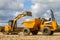 A digger tipping soil into a site dumper truck