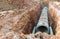 Digging and row of Concrete Drainage Pipe on a Construction Site .Concrete pipe stacked sewage water system aligned on site.