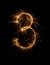 Digit 3 or three made of bengal fire, sparkler fireworks candle isolated on a black background