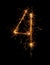 Digit 4 or four made of bengal fire, sparkler fireworks candle isolated on a black background