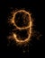 Digit 9 or nine made of bengal fire, sparkler fireworks candle isolated on a black background