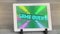 Digital animation of game over text against glowing tunnel on screen of digital tablet on wooden sur