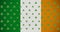 Digital animation of multiple clover leaves moving against irish flag