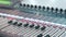 Digital audio workstation with an audio console. Soundboard knobs. Close up. DOF