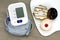 Digital Blood Pressure Monitor and Donut, Unhealthy food.