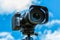 Digital camera closeup on a background of sky and clouds. Shooting on location and nature