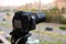 A digital camera fixed on a tripod for time lapse footage and video recording with a blurred top view of a city street