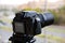 A digital camera fixed on a tripod for time lapse footage and video recording with a blurred top view of a city street