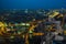 Digital camera over tripod on cityscape buildings at night