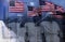 Digital composite: American flags and reflection of sailors saluting The Wall Vietnam War Memorial
