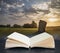 Digital composite concept image of open book wth Stunning Summer sunrise landscape of Neolithic standing stones in English