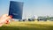 Digital composite of holding a generic passport with a row of commercial airplanes on taxiing on tarmac