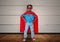 Digital composite image of boy pretending to be a superhero