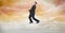 Digital composite image of businessman balancing on rope