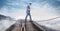 Digital composite image of businessman walking on rope over railway tracks