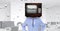 Digital composite image of businessman wearing television in head with networking background