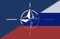 Digital composite image of flag of nato and russia painted, copy space