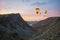 Digital composite image of hot air balloons over Stunning colorful landscape image of view down Honister Pass to Buttermere from