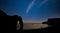 Digital composite image of Neowise Comet over Beautiful silhouette landscape image of Durdle Door in England