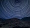 Digital composite image of star trails around Polaris with Stunning vibrant Catbells near Derwentwater in the Lake District with