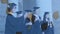 Digital composite video of graduation hats falling against group of graduates posing for pictures