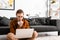 Digital designer working on laptop on floor in office