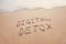 Digital detox concept, words written on the sand outdoor