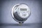 Digital electric meter with lcd screen  on grey dirty background. Electricity consumption concept