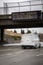 Digital freeway sign at overpass with message stating â€œStop The Spread ,Stay Home, Save Livesâ€ and traffic blurred