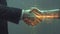 Digital generated human hand and businessman shaking hands.