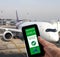 Digital green pass Covid-19 of EU on smartphone held by hand with a commercial airliner in the background. Safe travelling Concept