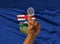 Digital ID Alberta on finger of dark skin person and Canadian province flag on background