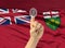 Digital ID number on finger of white skin person and Canadian province flag on background - Ontario