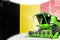 Digital industrial 3D illustration of green advanced rural combine harvester on Belgium flag - agriculture equipment innovation