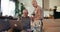 DIGITAL LITERACY AND SAFETY Happy senior Caucasian retired 70s man and woman use laptop to shop online at home on couch.