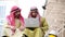 Digital marketing group arab people using smart tablet walking in  modern muslim UAE city touch screen discussion. Entrepreneur As