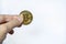 Digital Money and Cryptocurrency Concept. Closeup of gold bitcoin coin on mand hand on white background with copy sapce