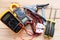 Digital multimeter, clamp-on meter with probes, electrical measuring instruments, and screwdrivers  on wooden