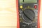 Digital multimeter closeup on a wooden table