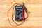 Digital multimeter and wiring on wooden table. special tools of technician for work with circuit and electrical. technician use