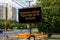 Digital road sign by a suburban street that says Coronavirus Testing Site Ahead.